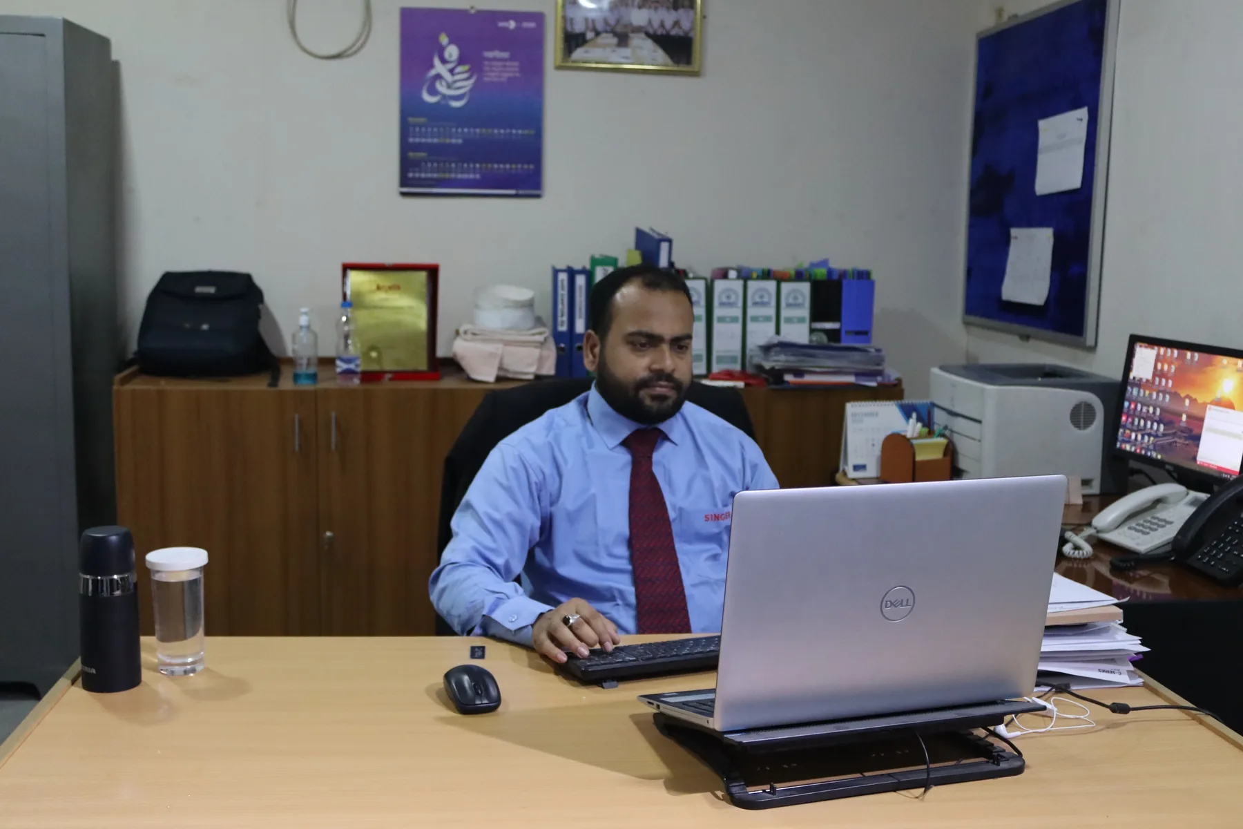 Moniruzzaman Mia working at his desk in an engineering office
